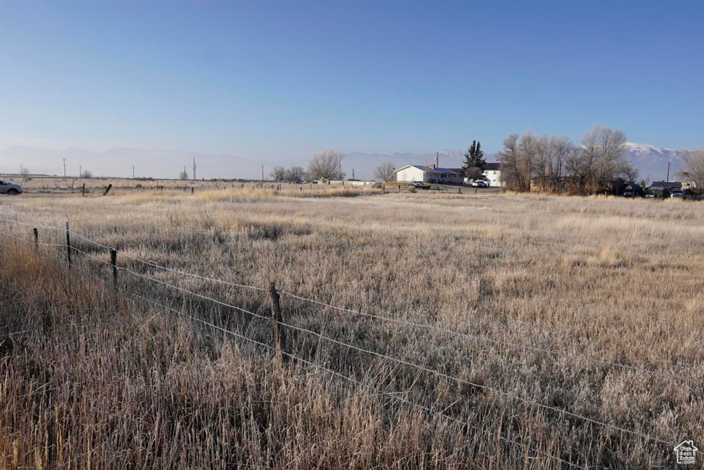 View of yard featuring a rural view and a mountain view