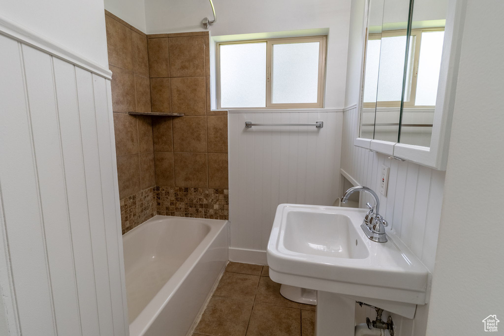 Full bathroom featuring tile patterned floors, shower / bathtub combination, and a wainscoted wall