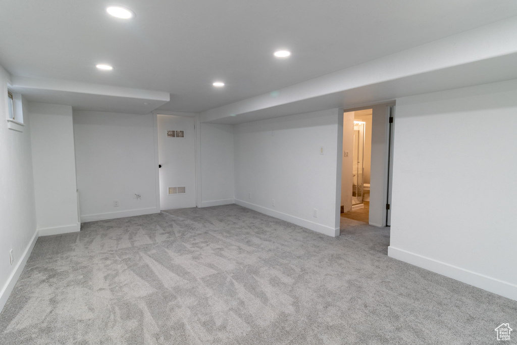 Finished below grade area with recessed lighting, carpet, and baseboards