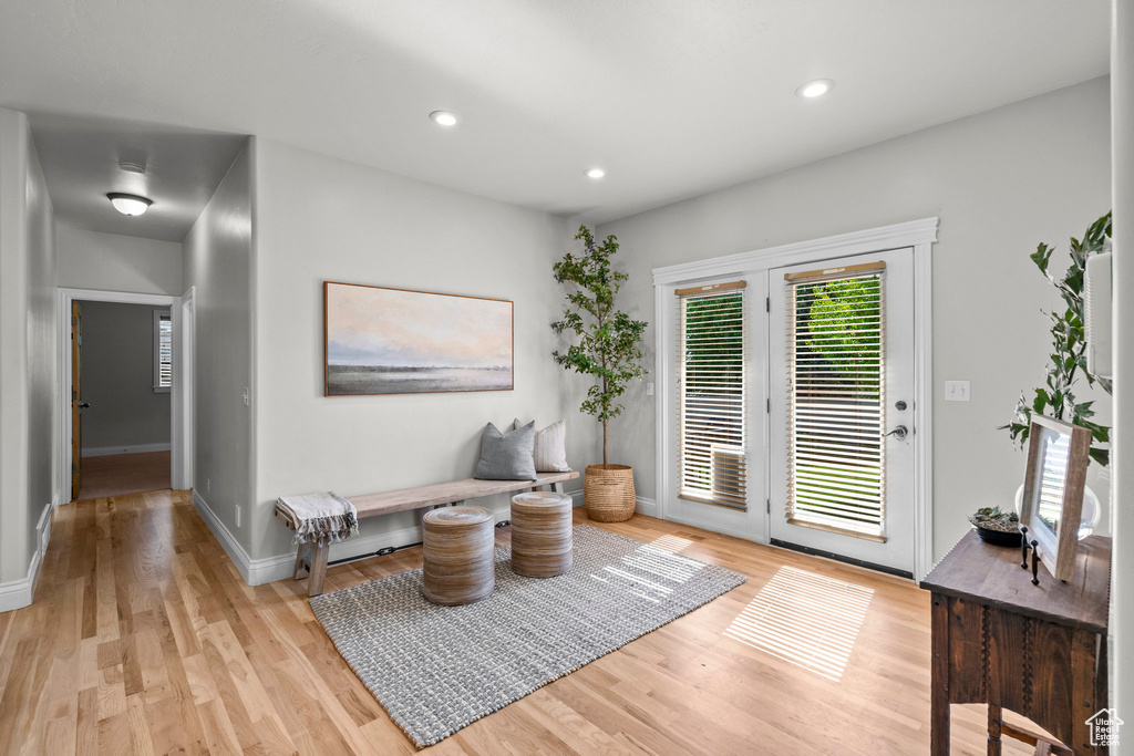 Sitting room featuring light wood-type flooring, baseboards, and recessed lighting