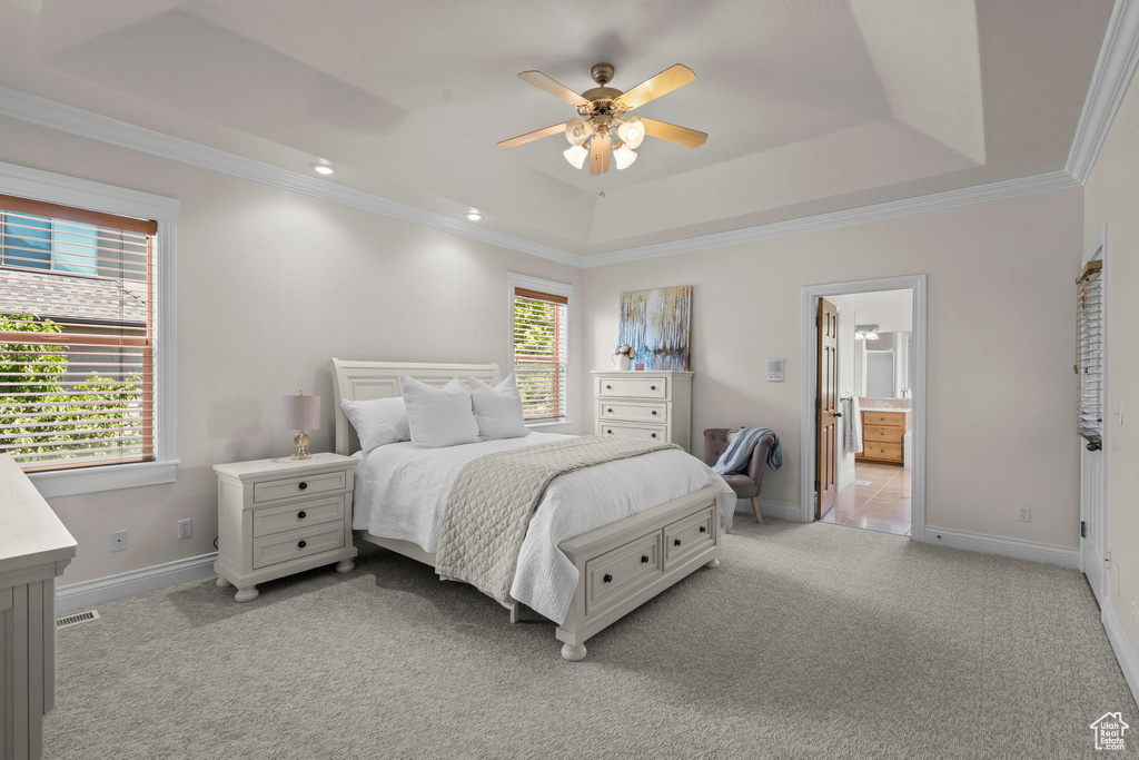 Bedroom featuring light carpet, a raised ceiling, baseboards, crown molding, and recessed lighting