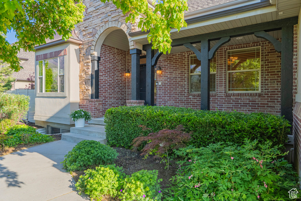 Entrance to property featuring brick siding