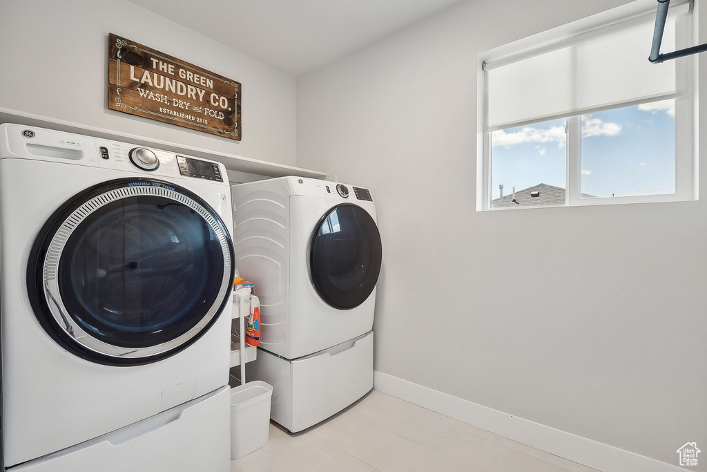 Laundry area featuring washer and clothes dryer and baseboards