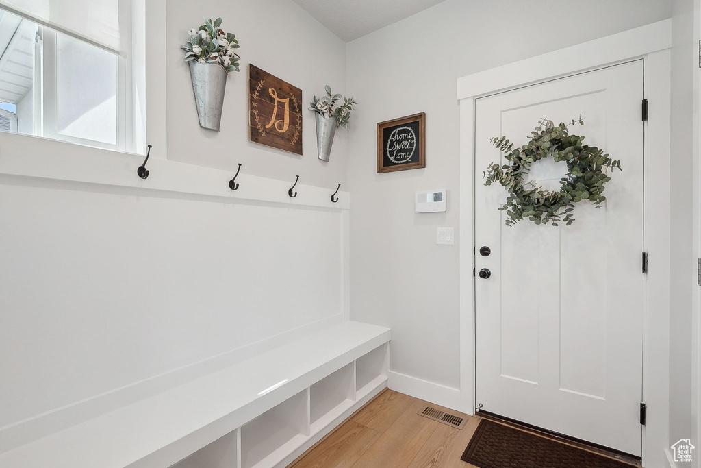 Mudroom with light wood-style floors and baseboards