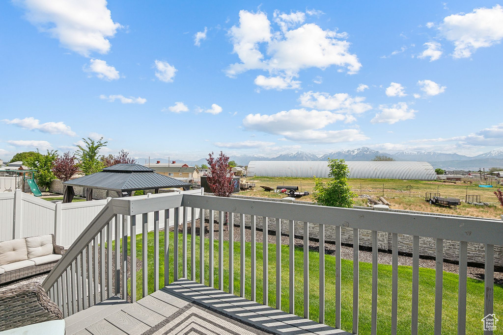 Wooden terrace featuring a mountain view and a gazebo