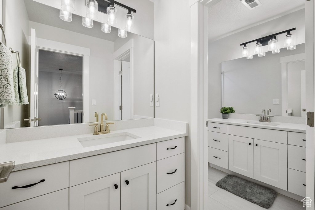 Full bath featuring two vanities