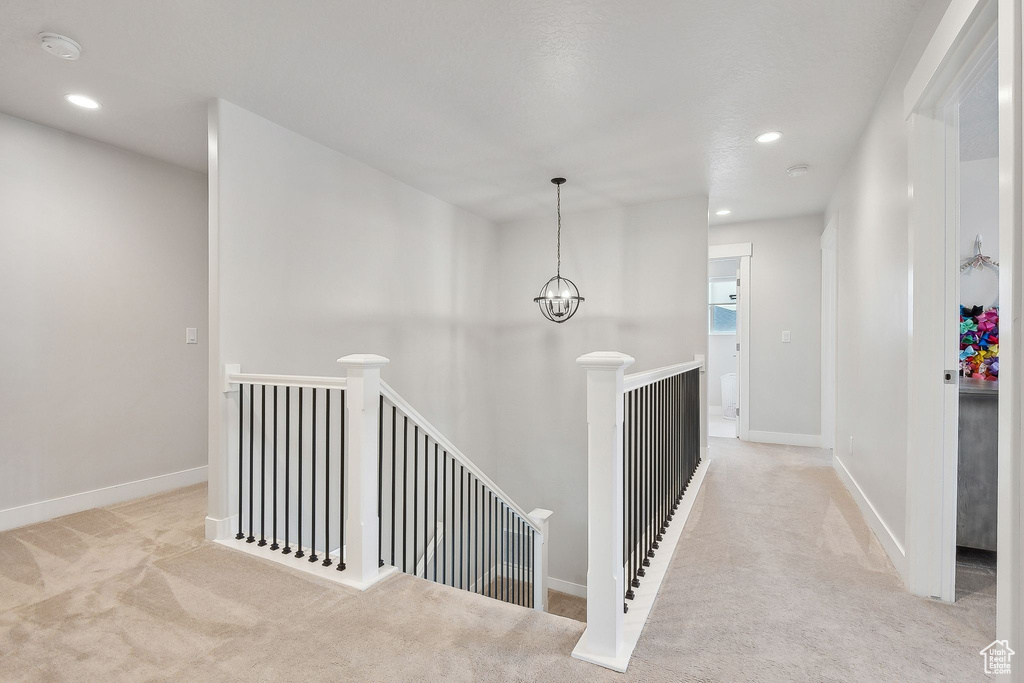 Corridor featuring an upstairs landing, carpet flooring, recessed lighting, and baseboards
