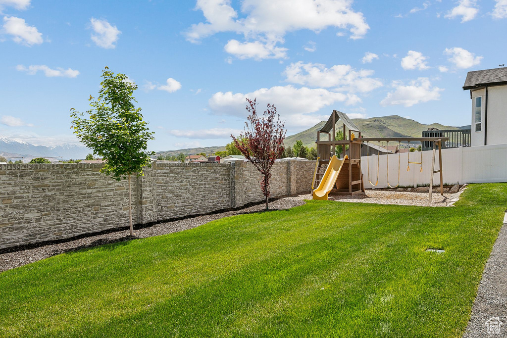 View of yard with a playground and a mountain view
