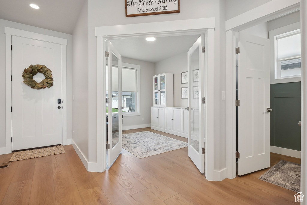 Foyer entrance with light wood-type flooring, baseboards, and recessed lighting