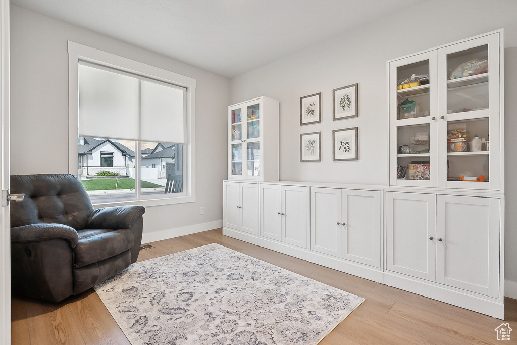 Living area featuring light wood-style flooring and baseboards