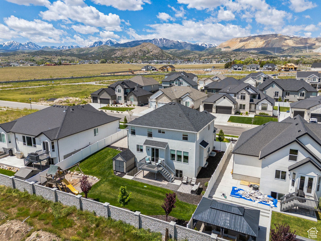 Aerial view of residential area featuring a mountainous background