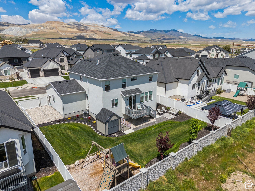 Aerial view of residential area featuring a mountainous background