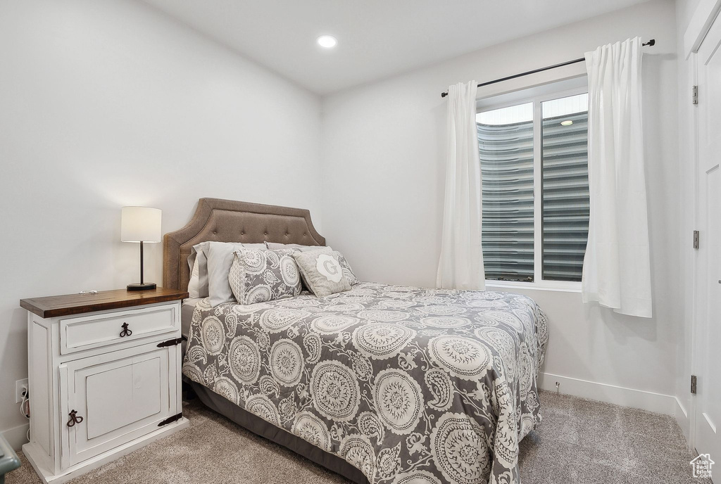 Bedroom featuring light colored carpet, recessed lighting, and baseboards