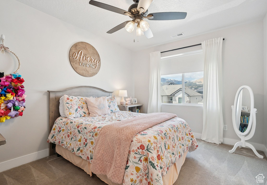 Carpeted bedroom with baseboards and ceiling fan