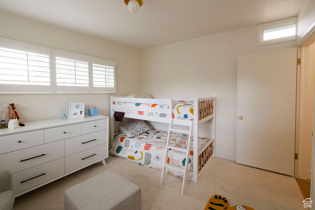 Bedroom featuring light colored carpet