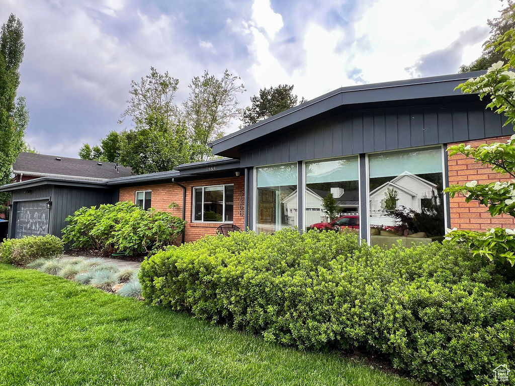 View of home\'s exterior with brick siding and an attached garage