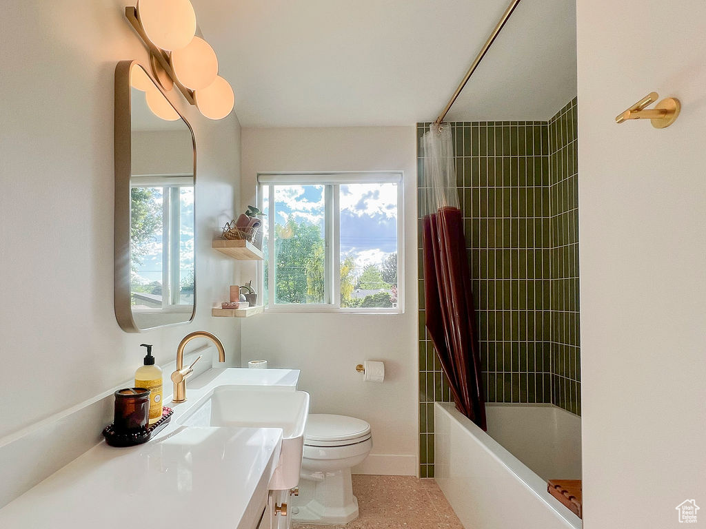 Full bathroom with toilet, vanity, and shower / bathtub combination with curtain