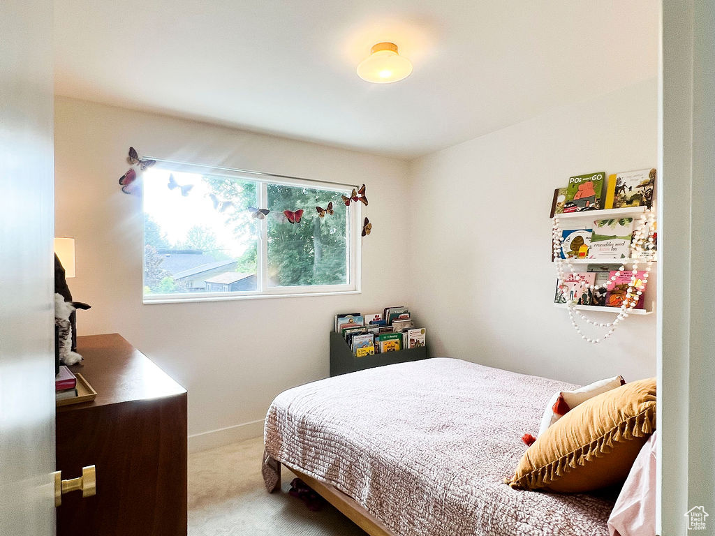 Bedroom with carpet flooring and baseboards