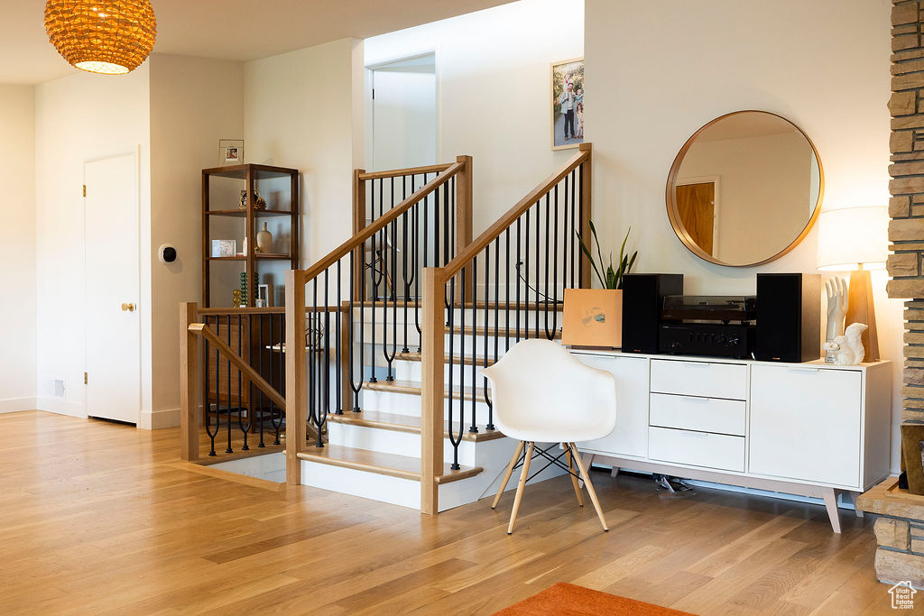 Stairs featuring wood finished floors and baseboards