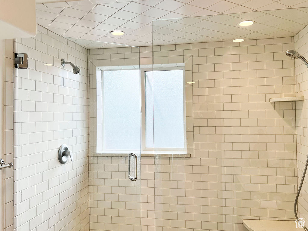 Bathroom featuring a shower stall and recessed lighting