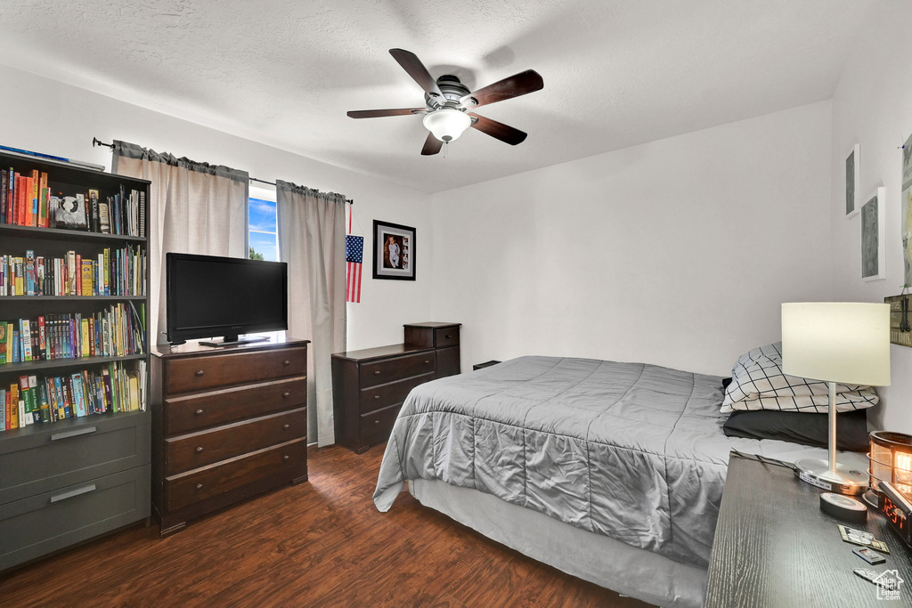 Bedroom with wood finished floors and a ceiling fan