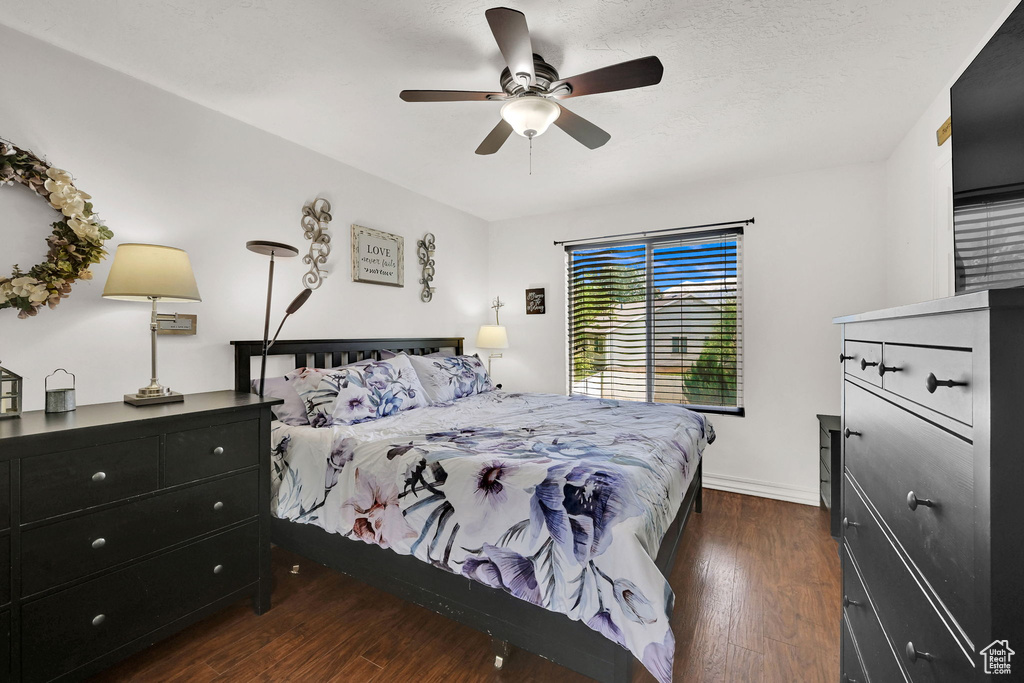 Bedroom featuring dark wood finished floors, ceiling fan, and baseboards
