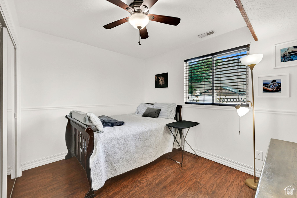 Bedroom featuring wood finished floors, baseboards, and a ceiling fan