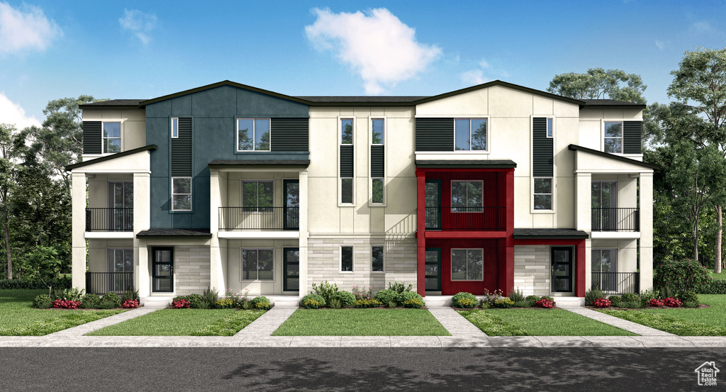 View of front facade featuring a front lawn and a balcony