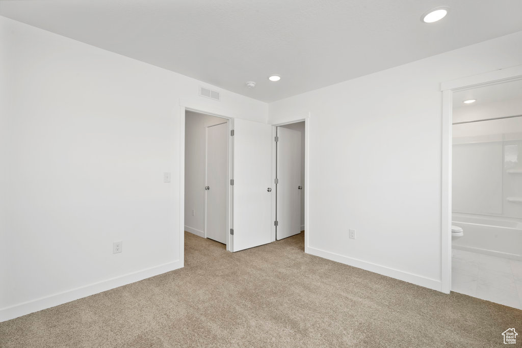 Unfurnished bedroom with carpet flooring, recessed lighting, baseboards, and connected bathroom