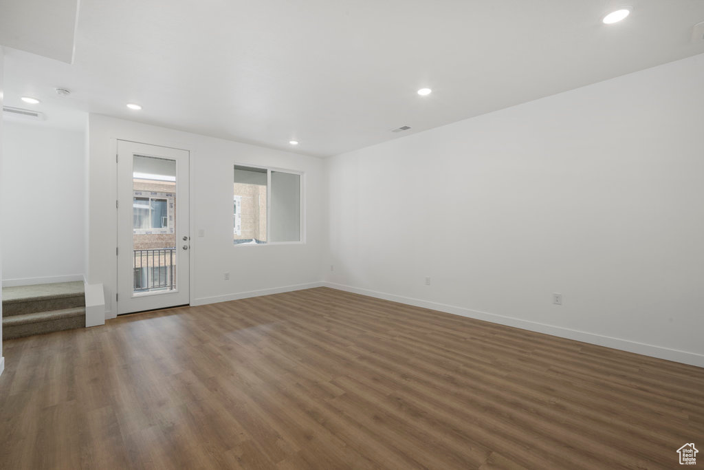 Spare room featuring wood finished floors, recessed lighting, and baseboards