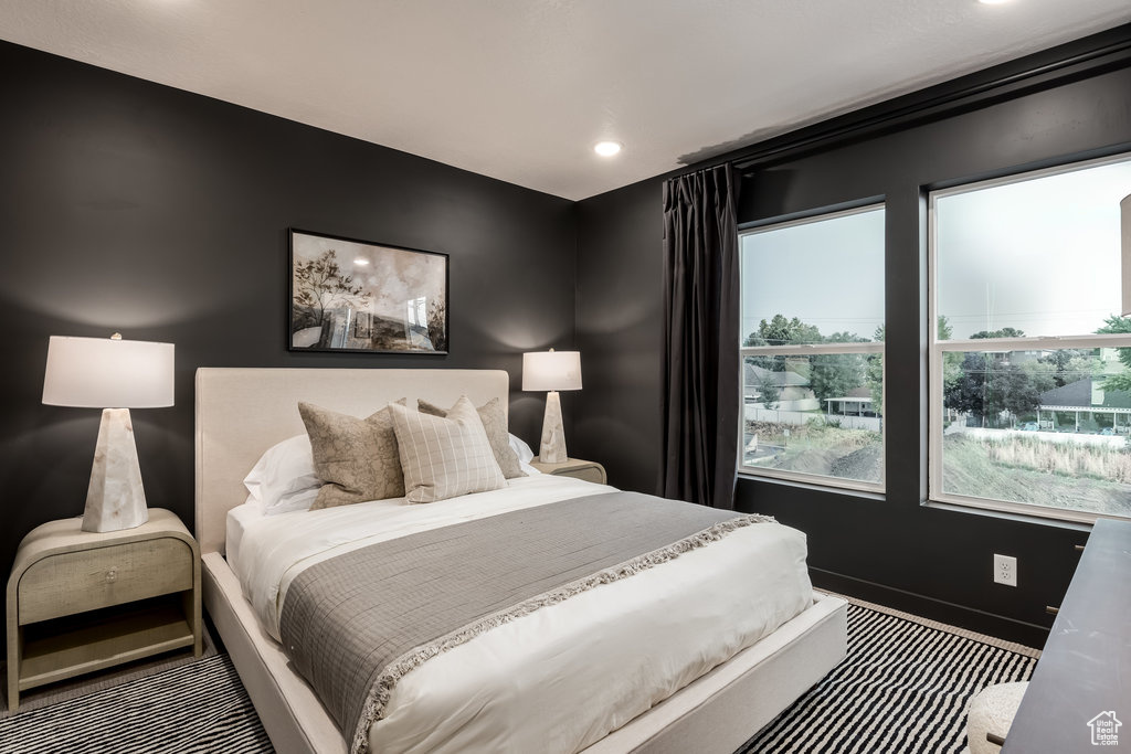 Carpeted bedroom with baseboards and recessed lighting