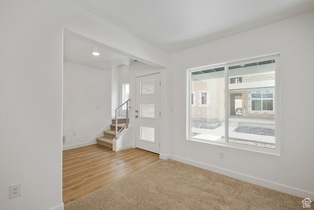 Entryway featuring healthy amount of natural light, stairway, and baseboards