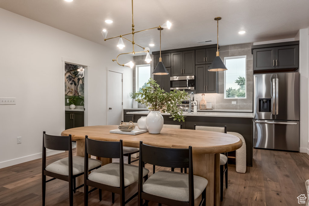 Dining space featuring plenty of natural light, baseboards, dark wood-style floors, and recessed lighting