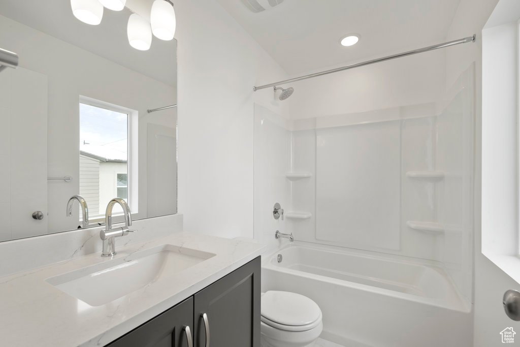 Bathroom featuring shower / washtub combination, vanity, toilet, and recessed lighting