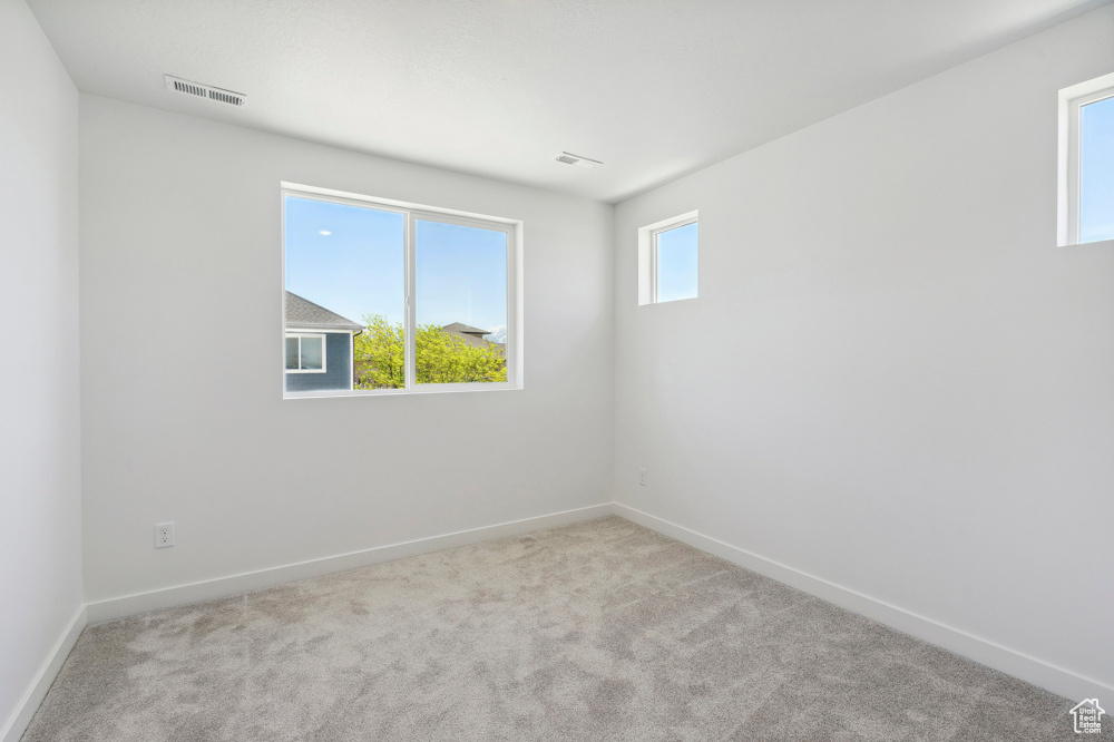 Empty room with carpet and baseboards