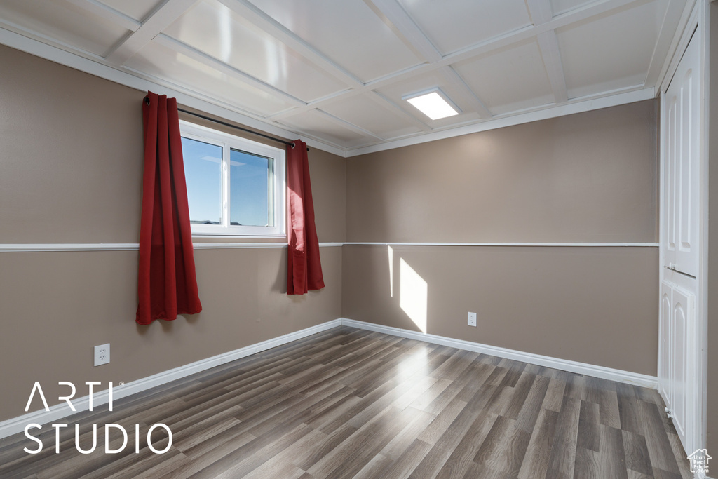 Empty room featuring wood finished floors and baseboards