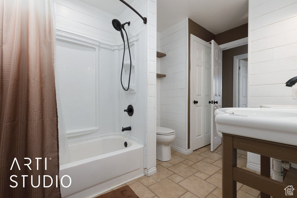 Bathroom featuring shower / bath combination with curtain, toilet, and vanity
