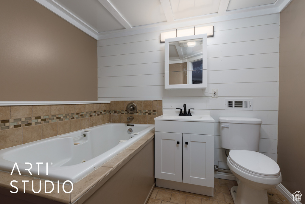 Full bath with a tub with jets, toilet, vanity, and tile patterned flooring