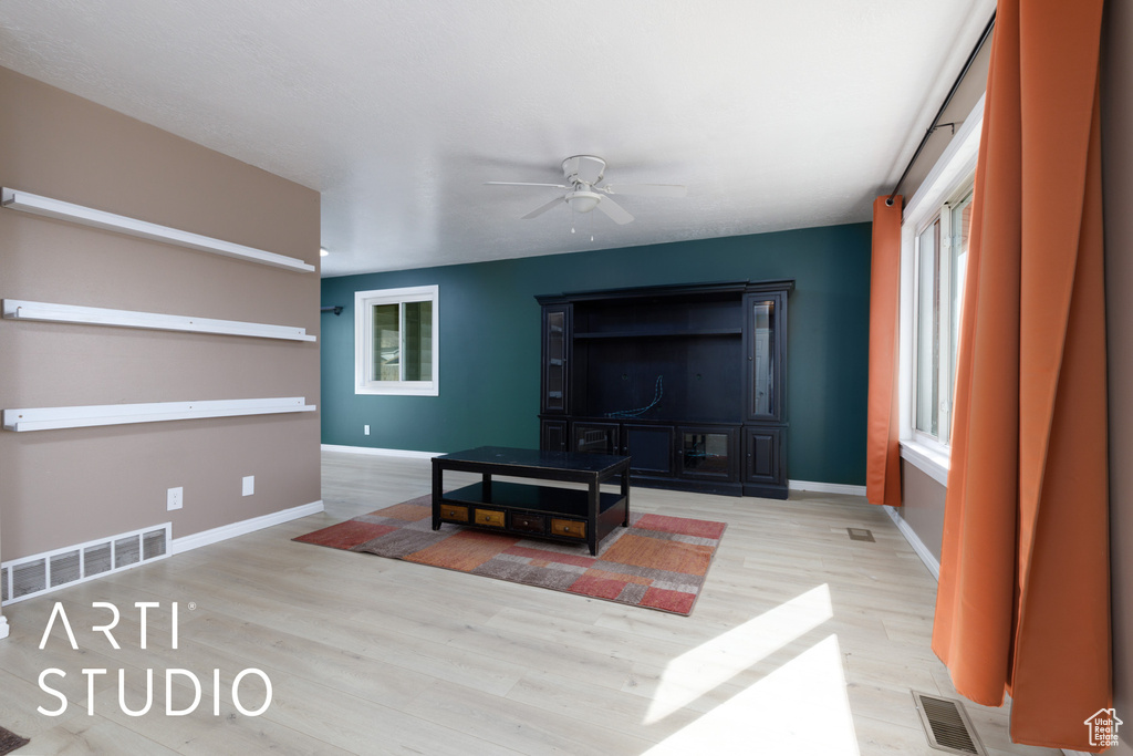 Living room featuring ceiling fan, wood finished floors, and baseboards
