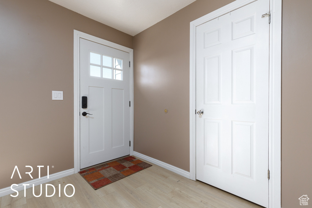 Entrance foyer featuring light wood-style floors and baseboards