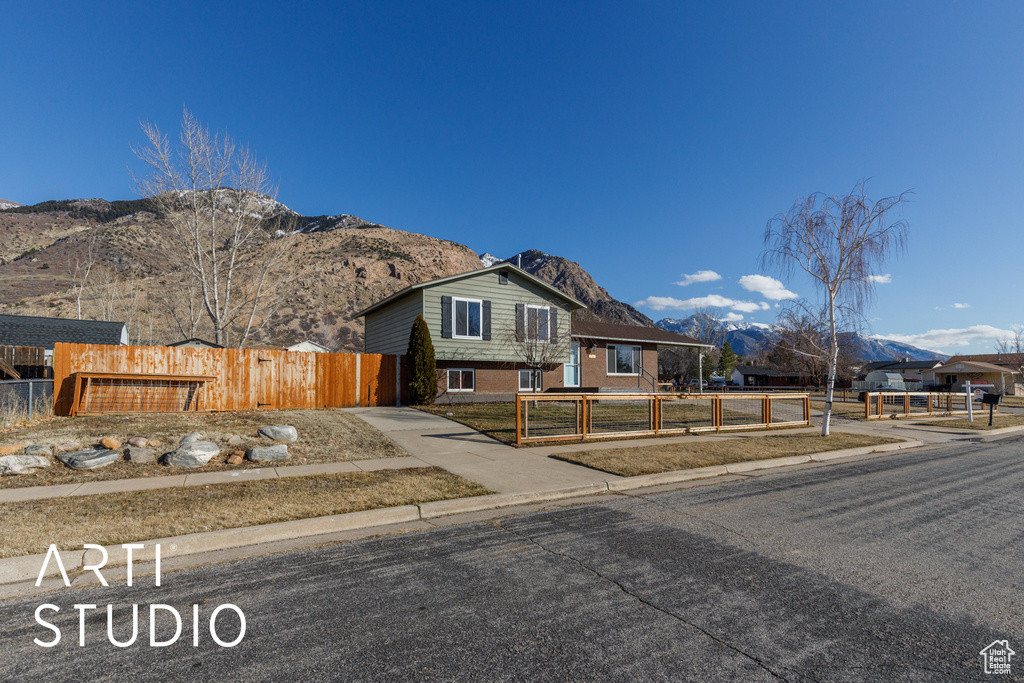 View of front of house featuring a mountain view and brick siding