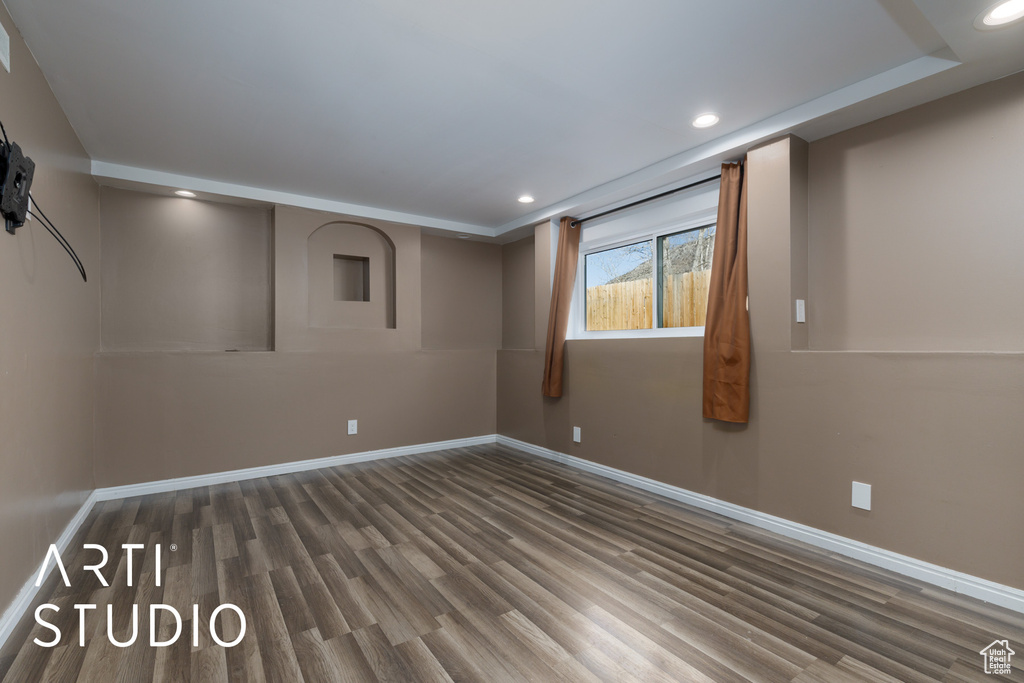 Unfurnished room featuring wood finished floors, baseboards, and recessed lighting