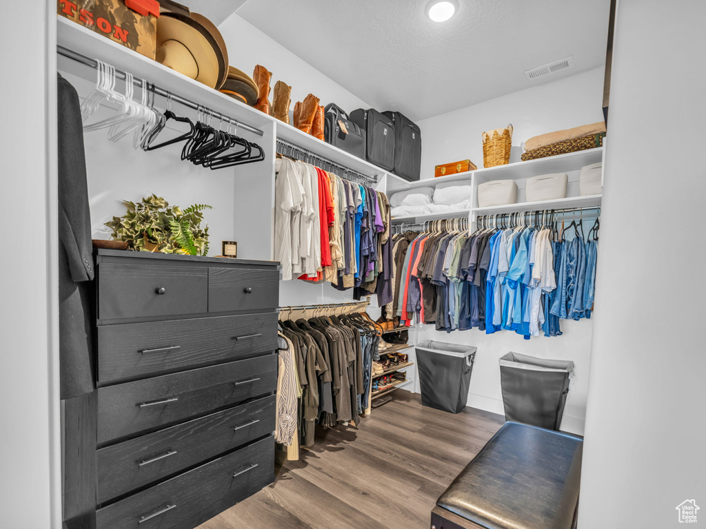 Walk in closet featuring wood finished floors