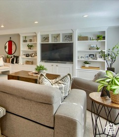Living area featuring built in shelves and recessed lighting