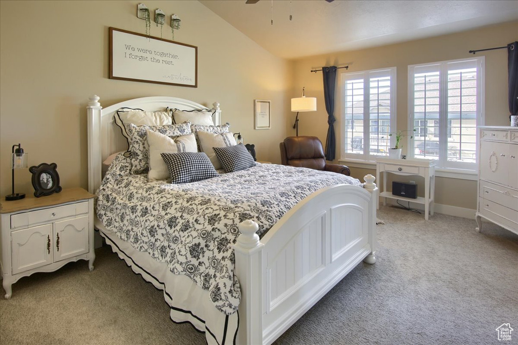 Carpeted bedroom with lofted ceiling