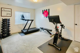 Exercise area with carpet flooring and baseboards