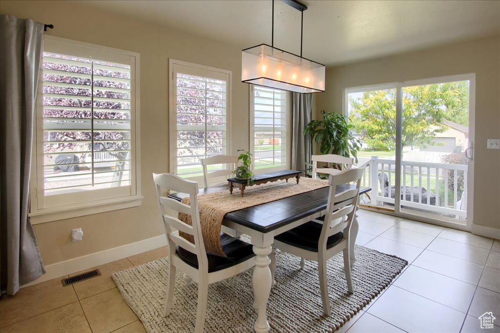 Dining area with light tile patterned floors and baseboards