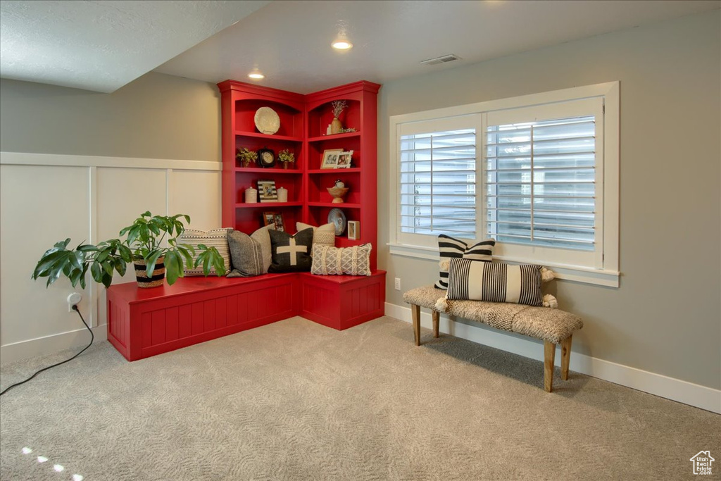 Sitting room featuring carpet and a wainscoted wall