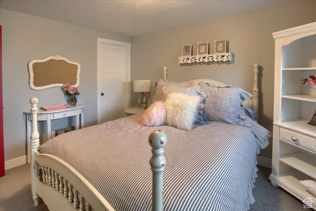 Carpeted bedroom featuring baseboards