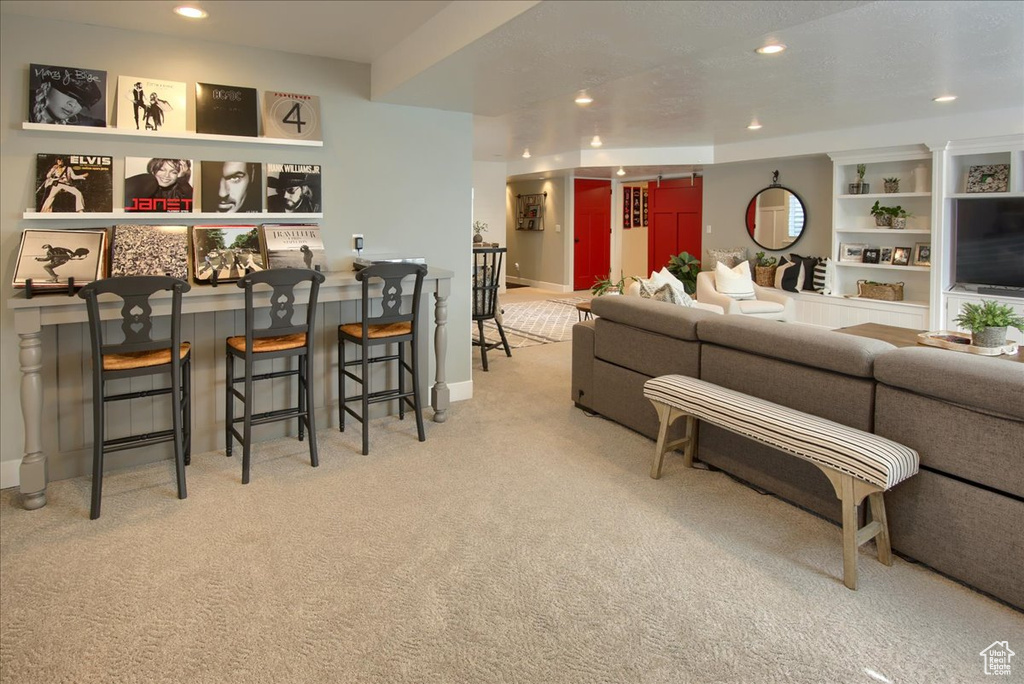 Living room with carpet, recessed lighting, and baseboards